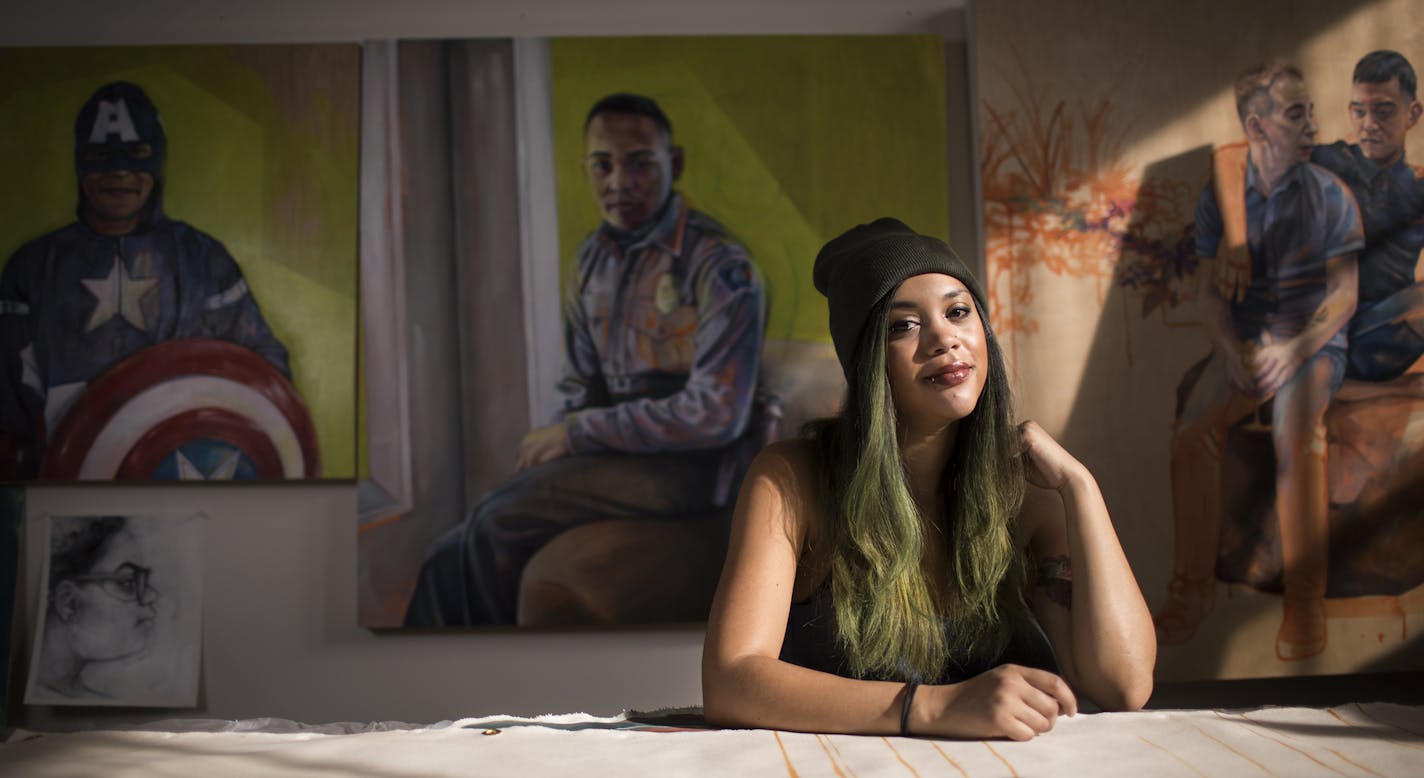 Artist Leslie Barlow poses for a photo in her studio with some of her paintings. ] LEILA NAVIDI &#xef; leila.navidi@startribune.com BACKGROUND INFORMATION: Artist Leslie Barlow poses for a photo in her studio in the Northrup King Building in Minneapolis on Thursday, February 16, 2017. Barlow paints people who look a little like her: Multiracial couples, families, friends. Her latest project -- large-scale portraits featuring interracial families -- was inspired by the 50th anniversary of the Lov