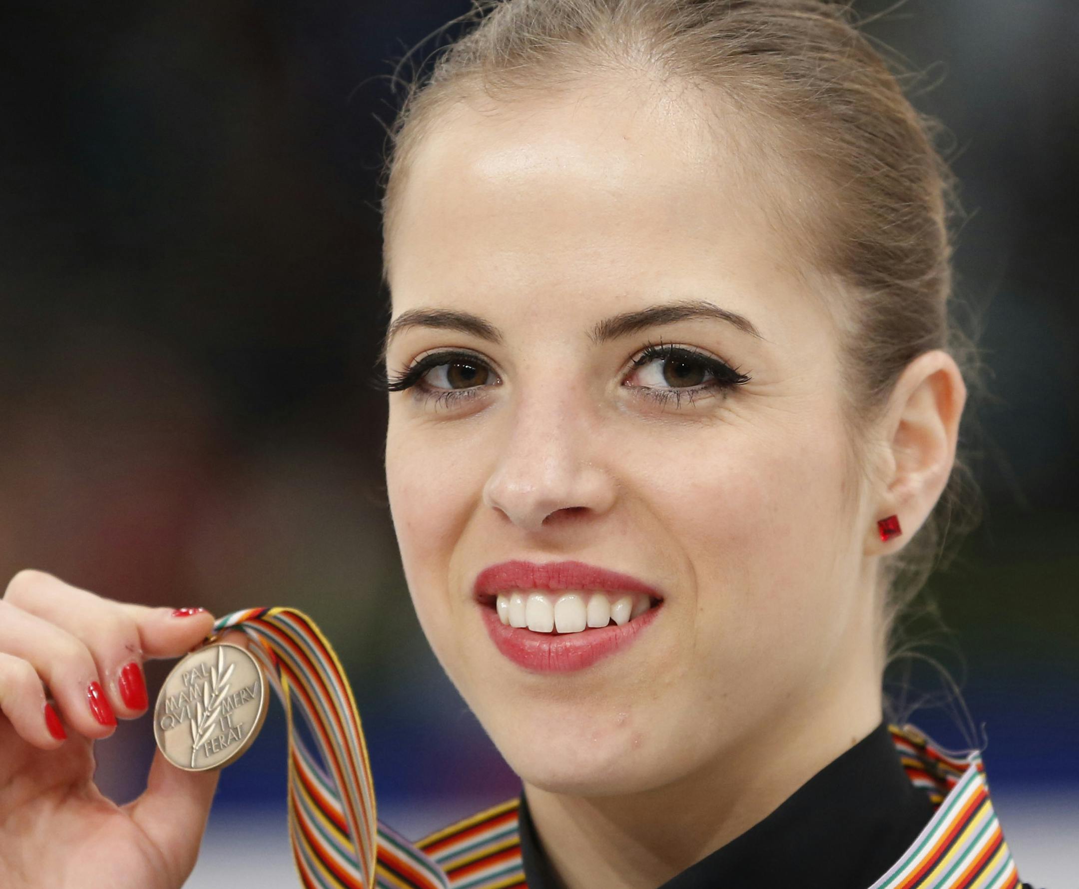 Italy's Carolina Kostner celebrates her bronze medal following the women's free skating at the European Figure Skating Championships in Budapest, Hungary, Friday, Jan. 17, 2014. (AP Photo/Darko Bandic)