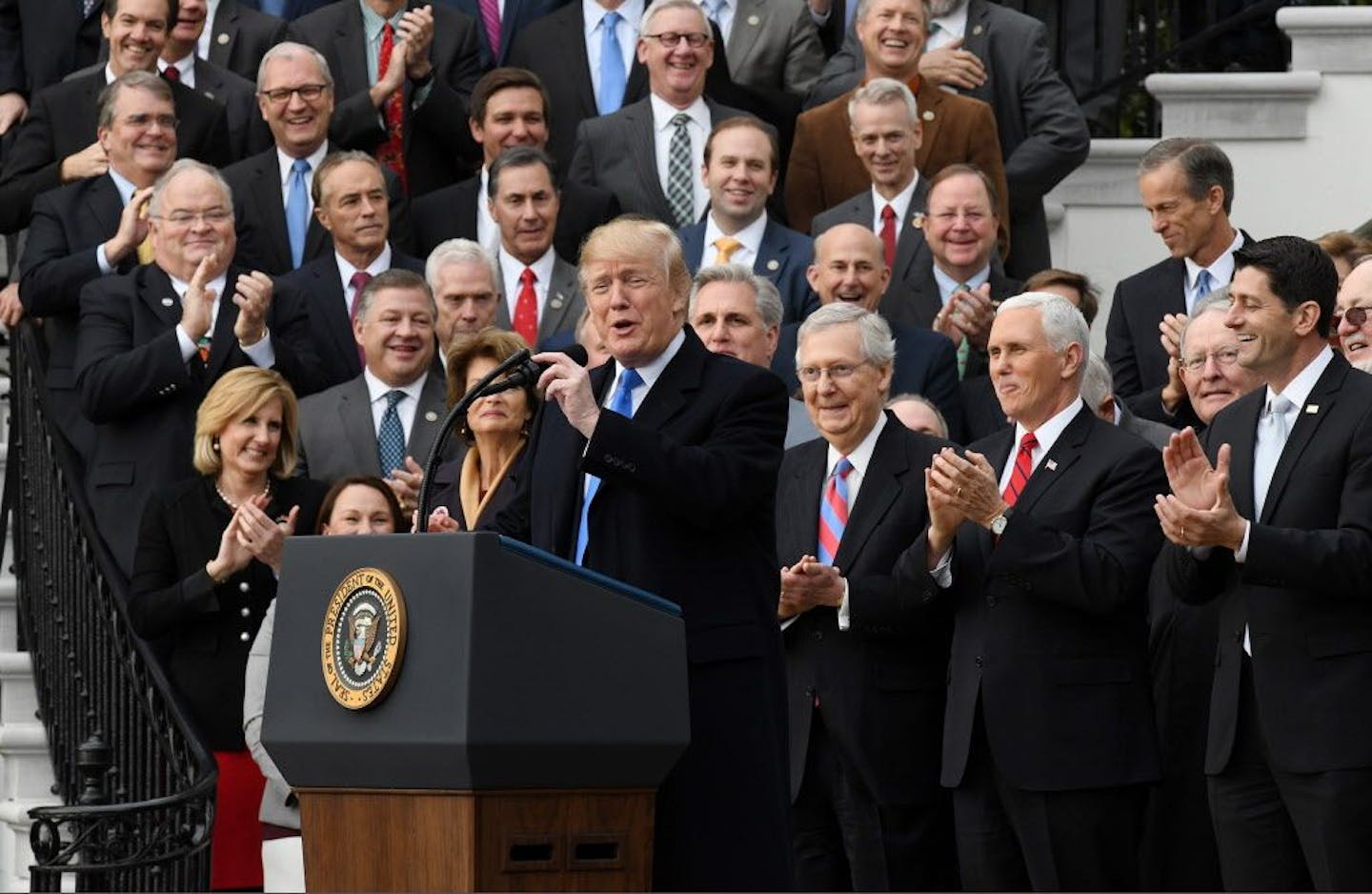 President Donald Trump celebrated the tax bill's passage at the White House with members of the House and Senate on Wednesday, Dec. 20, 2017 during an event on the South Portico of the White House in Washington, D.C.