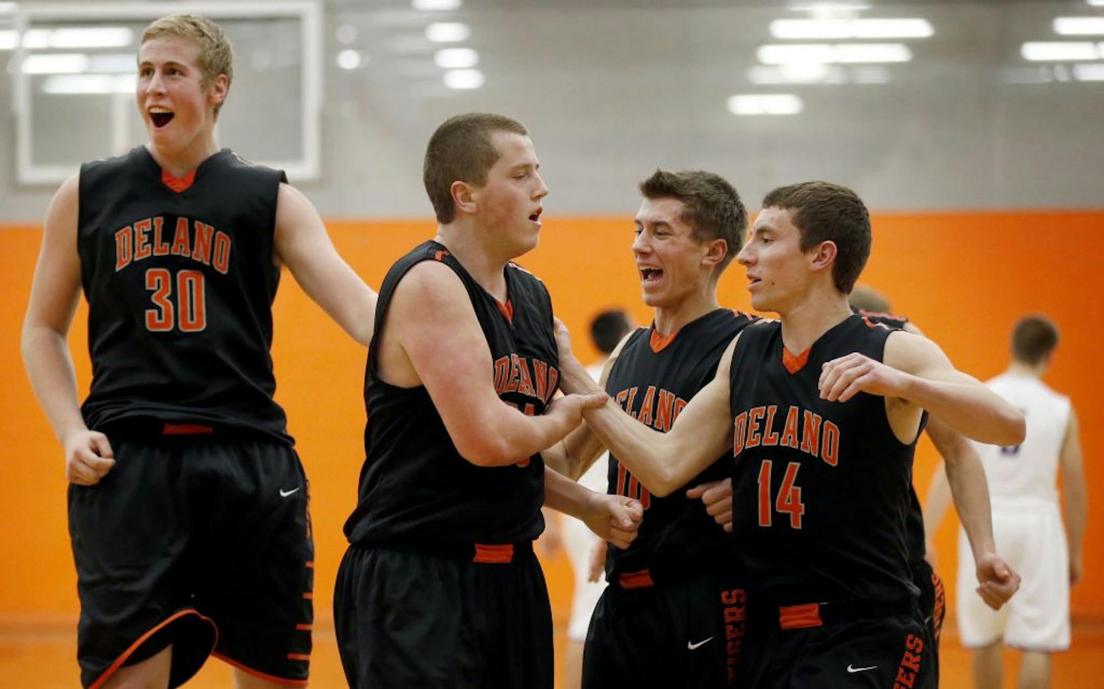 Delano players Damon Longstreet (30), Dalton Pulis (55), Adam Schleper (10) and Zach Muckenhirn (14) celebrated at the end of the game.