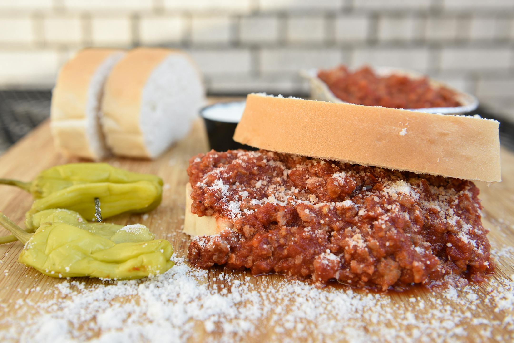 Messy Giuseppe: A blend of seasoned ground beef and Italian pork sausage smothered in marinara, sprinkled with Parmesan cheese and served on crusty Italian bread. At Mancini's al Fresco, located on the north side of Carnes Av. between Nelson & Underwood streets.