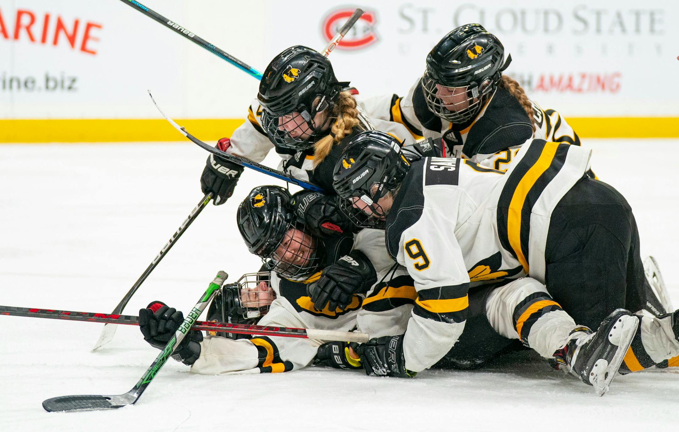 Warroad forward Kate Johnson (16) is swarmed by teammates after she scores her team's third goal against Proctor/Hermantown in the second period of the MSHSL state tournament Class 1A girls' hockey championship Saturday, Feb. 26, 2022 at Xcel Energy Center in St. Paul, Minn. ]