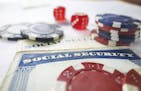Social Security cards with dice and poker chips