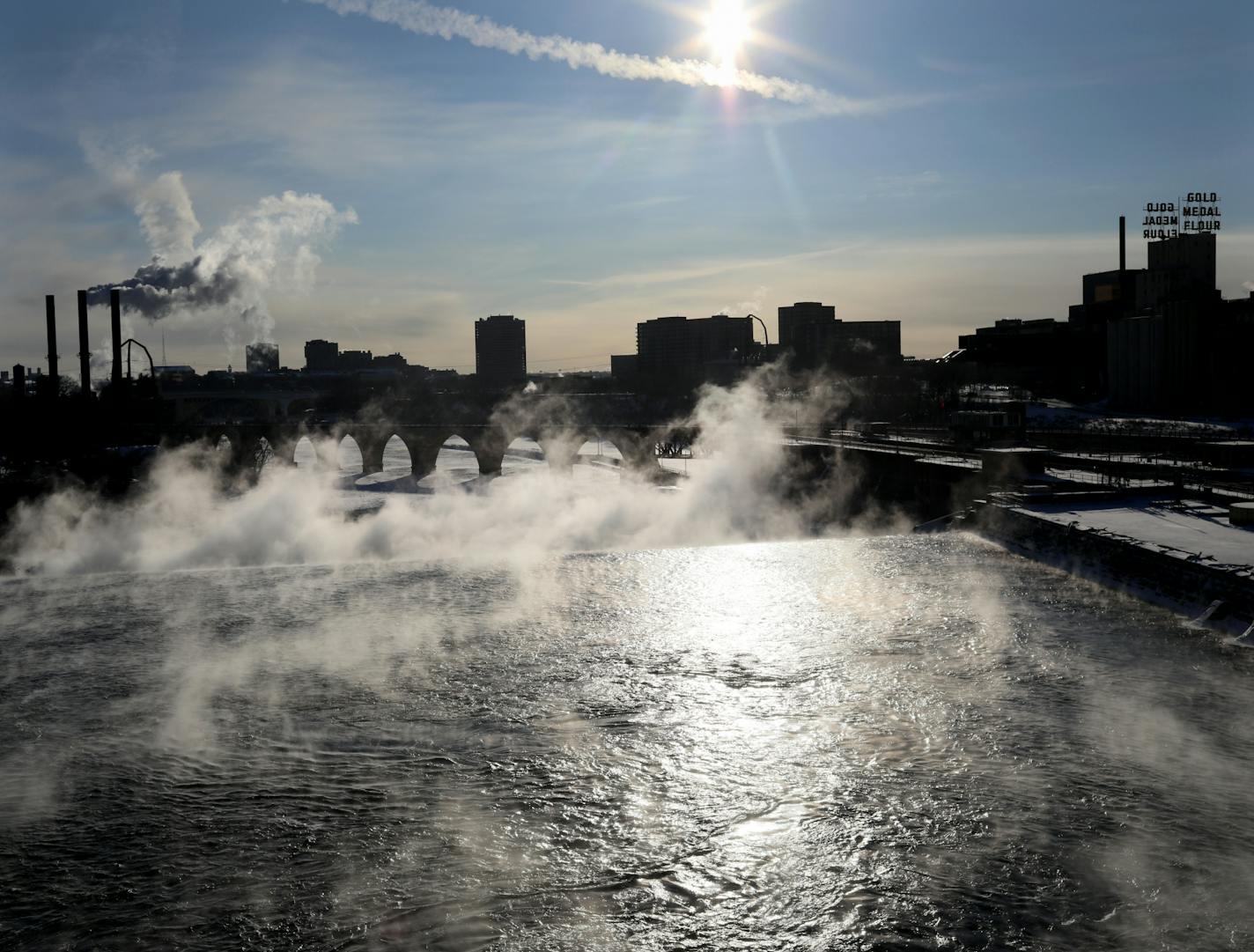 Water vapor rises above St. Anthony Falls on the Mississippi River, seen from the Third Ave. Bridge Tuesday, Jan. 29, 2019, In Minneapolis, MN.