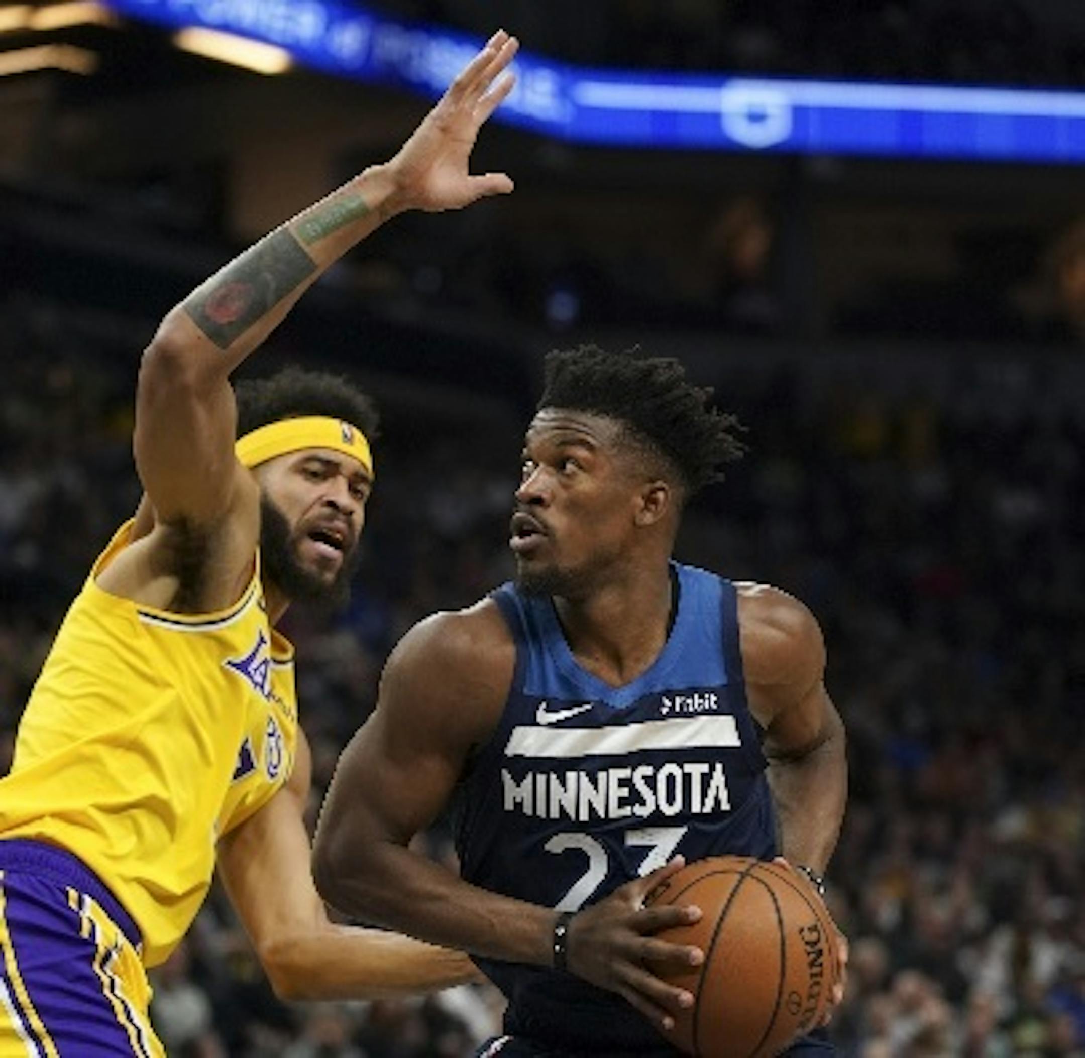 Timberwolves guard Jimmy Butler looked for a shot in the first quarter while guarded by Lakers center JaVale McGee (7). Butler went on to score 32 points in the Wolves' 124-120 victory.