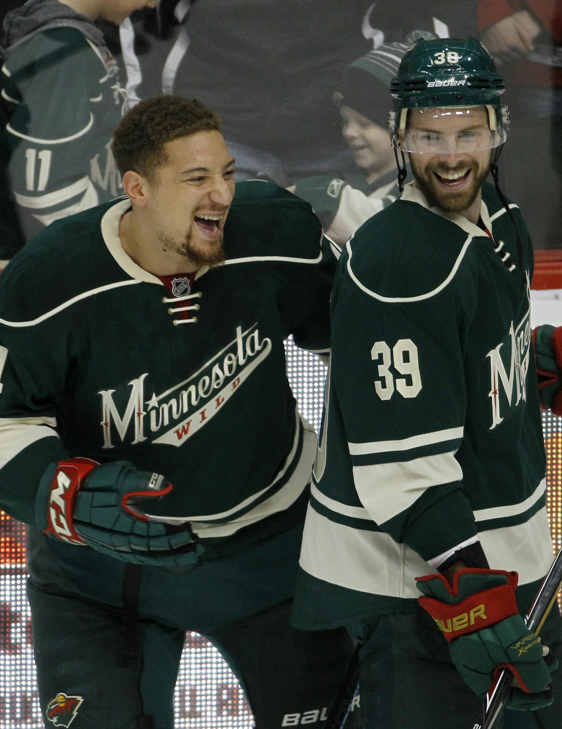 Minnesota Wild right wing Chris Stewart (44) laughs with teammate Nate Prosser (39) before an NHL hockey game against the Colorado Avalanche in St. Paul, Minn., Sunday, March 8, 2015. (AP Photo/Ann Heisenfelt) ORG XMIT: MIN2015032311420939 ORG XMIT: MIN1503251721384218