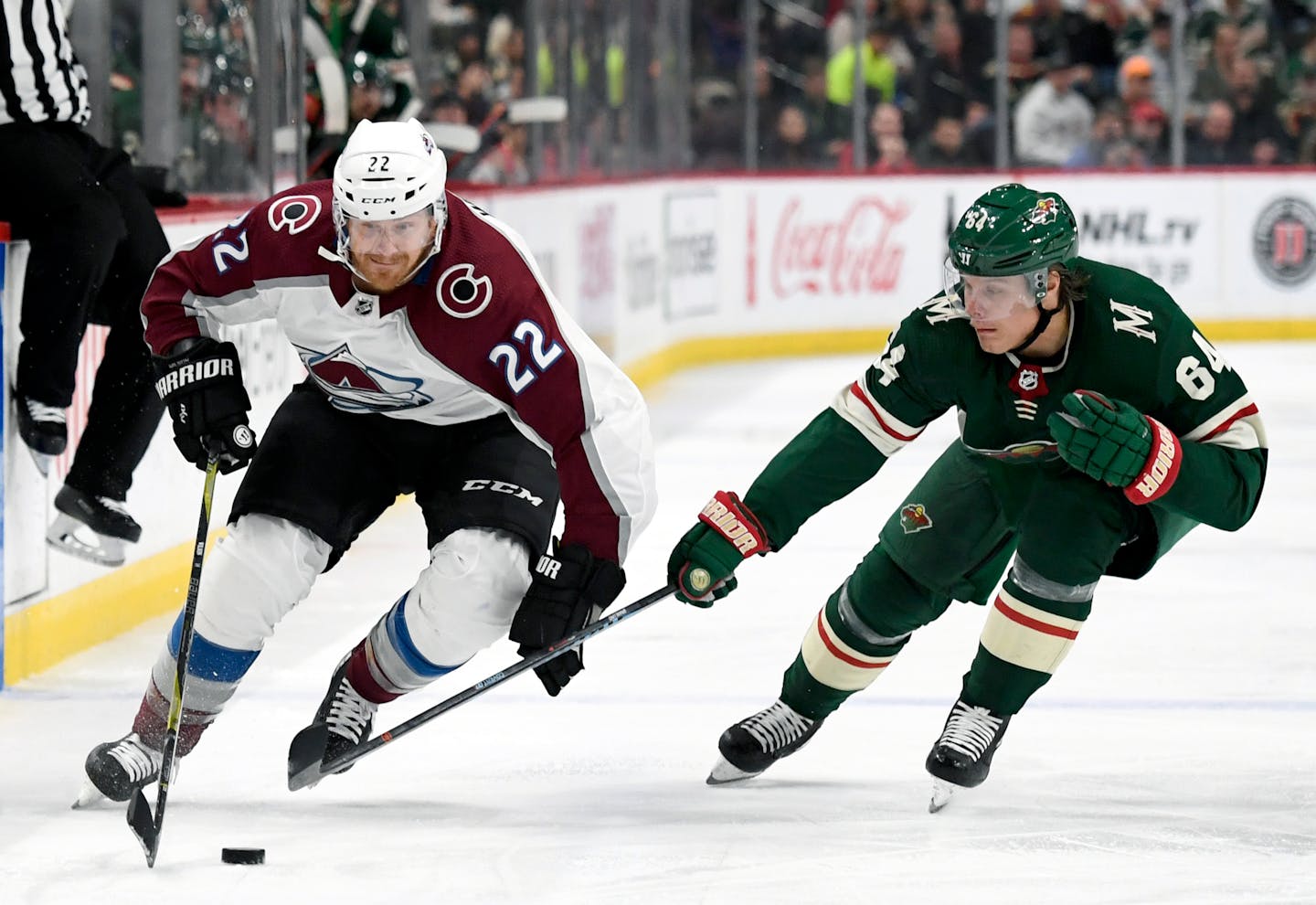 Colorado Avalanche's Colin Wilson (22) skates past Minnesota Wild's Mikael Granlund (64), of Finland, during the second period of an NHL hockey game Saturday, Oct. 27, 2018, in St. Paul, Minn. (AP Photo/Hannah Foslien)