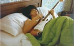 Prince lying in bed with guitar (&#xa9; 1986 Joseph Giannetti) CAPTION: Prince plays a guitar in bed at his new home on France Avenue, April 1978.