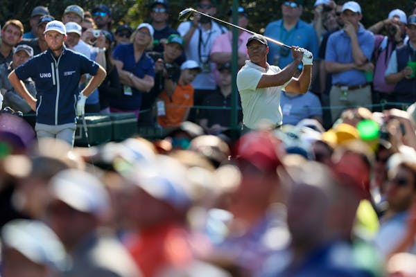 Tiger Woods tees off during a practice round at the Masters on Monday.