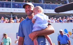 Scottie Scheffler holds his son, Bennett, after winning the CJ Cup Byron Nelson on Sunday in McKinney, Texas.