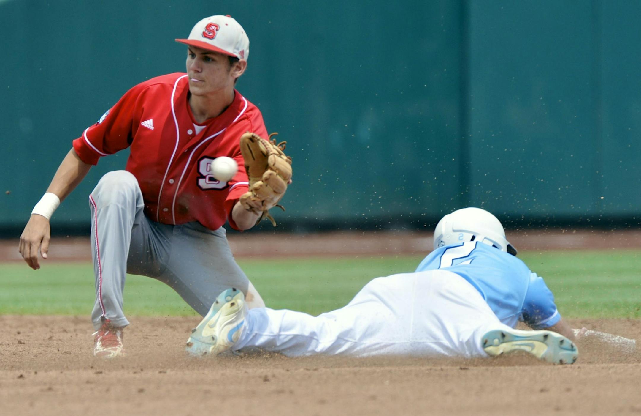 North Carolina's Chaz Frank (2) steals second base ahead of the throw to North Carolina State shortstop Trea Turner, left, in the first inning of an NCAA College World Series baseball game in Omaha, Neb., Sunday, June 16, 2013. (AP Photo/Ted Kirk)