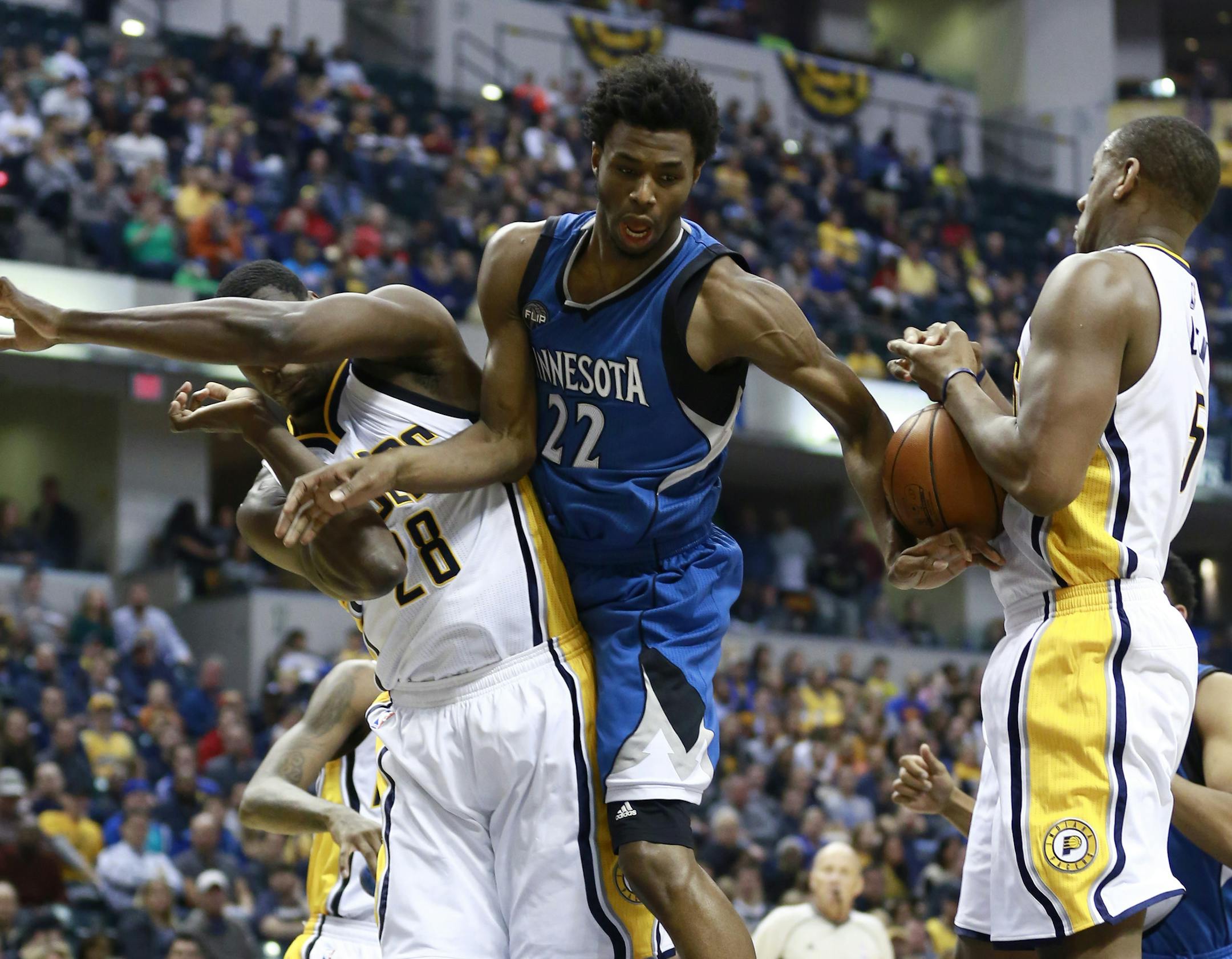 Minnesota Timberwolves guard Andrew Wiggins (22) loses control of the ball defended by Indiana Pacers center Ian Mahinmi, left, and Pacers center Lavoy Allen in the first half of an NBA basketball game, Friday, Nov. 13, 2015, in Indianapolis. (AP Photo/R Brent Smith)