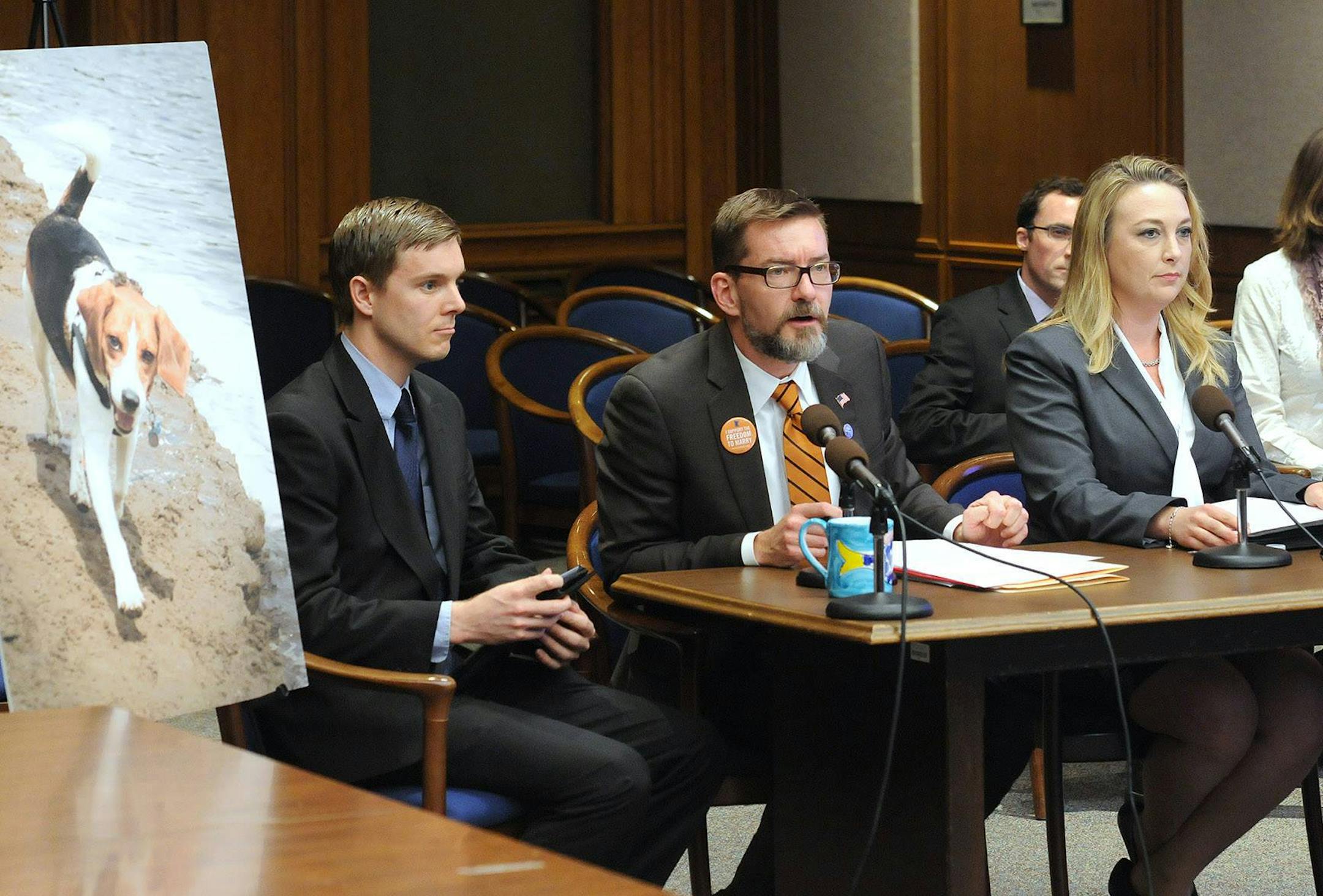 Sen. Scott Dibble, DFL-Minneapolis, speaks before the Senate Higher Education Committee in 2013 in favor of a bill making laboratory animals available for adoption. To the right is Shannon Keith, president of the Beagle Freedom Project, and to the left is Aaron Zellhoefer, who adopted the former research dog pictured.