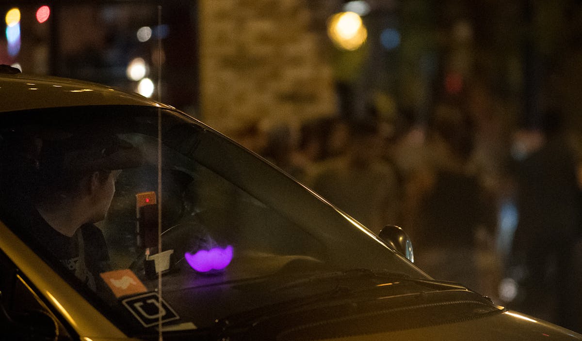 An Uber and Lyft driver waited to pick up passengers at Lagoon Avenue and Hennepin Avenue after bar closing time in August.