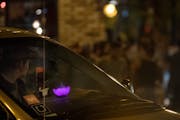 An Uber and Lyft driver waited to pick up passengers at Lagoon Avenue and Hennepin Avenue after bar closing time in August.