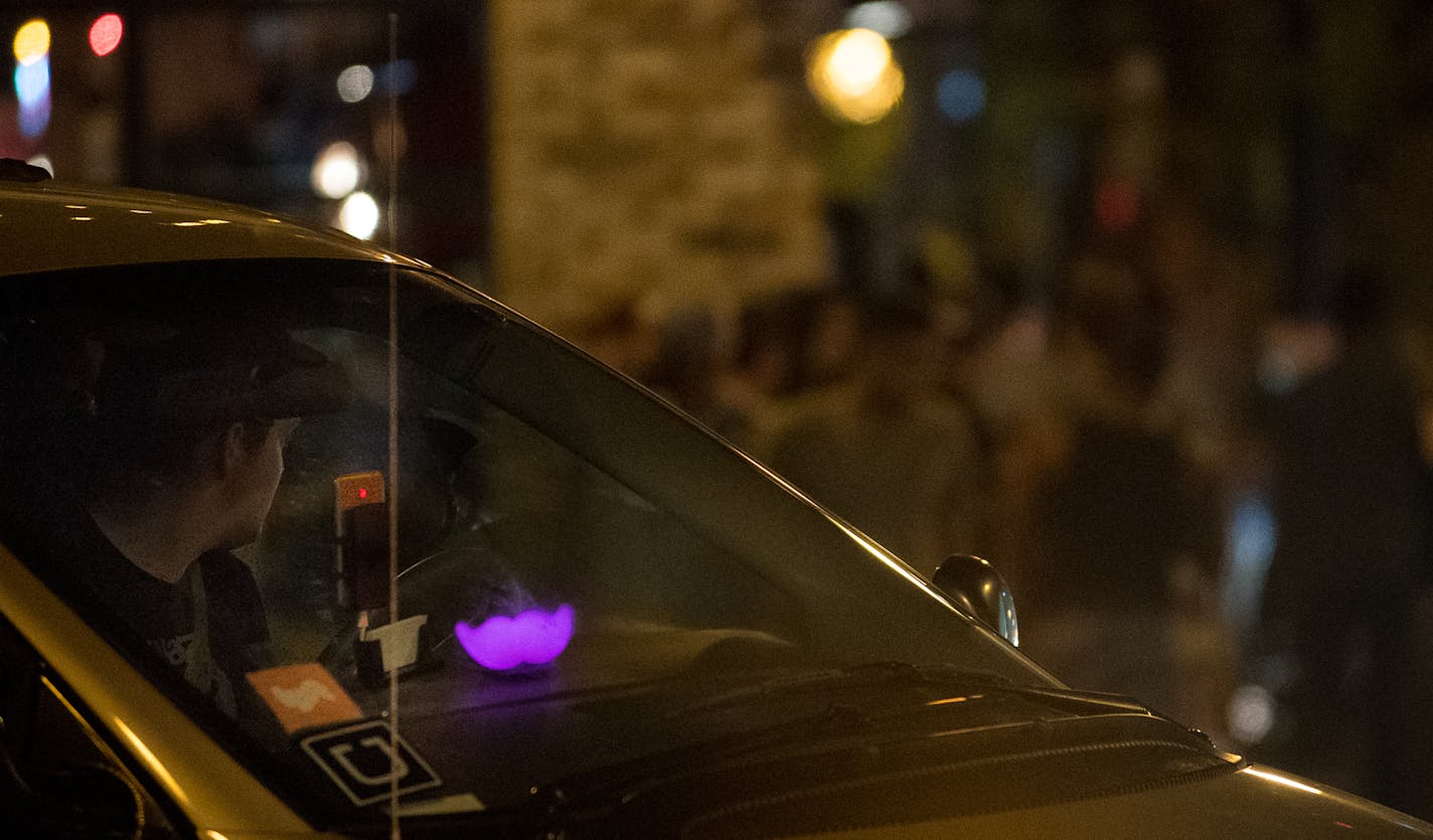 An Uber and Lyft driver waited to pick up passengers at Lagoon Avenue and Hennepin Avenue after bar closing time in August.