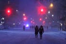 Pedestrians walk up a snowy Third Avenue in New York as a vehicular travel ban remained in effect, Jan. 23, 2016. With 16 inches of snow in the city b