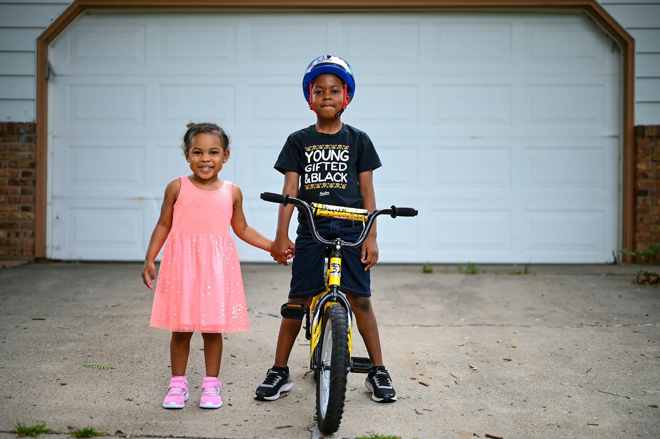 D.J. Buford, 6, stood for a portrait with his 3-year old sister, Jordyn, outside their Bloomington home Thursday afternoon. "I don't get to go to birthday parties, or school" said D.J., who recently had to be pulled from his new daycare after possible COVID-19 exposure shut it down for two weeks. Buford misses school more than anything. "It's like peanut butter without jelly," said D.J., "the jelly is the school and I am the peanut butter and the peanut butter doesn't get to go to the jelly and