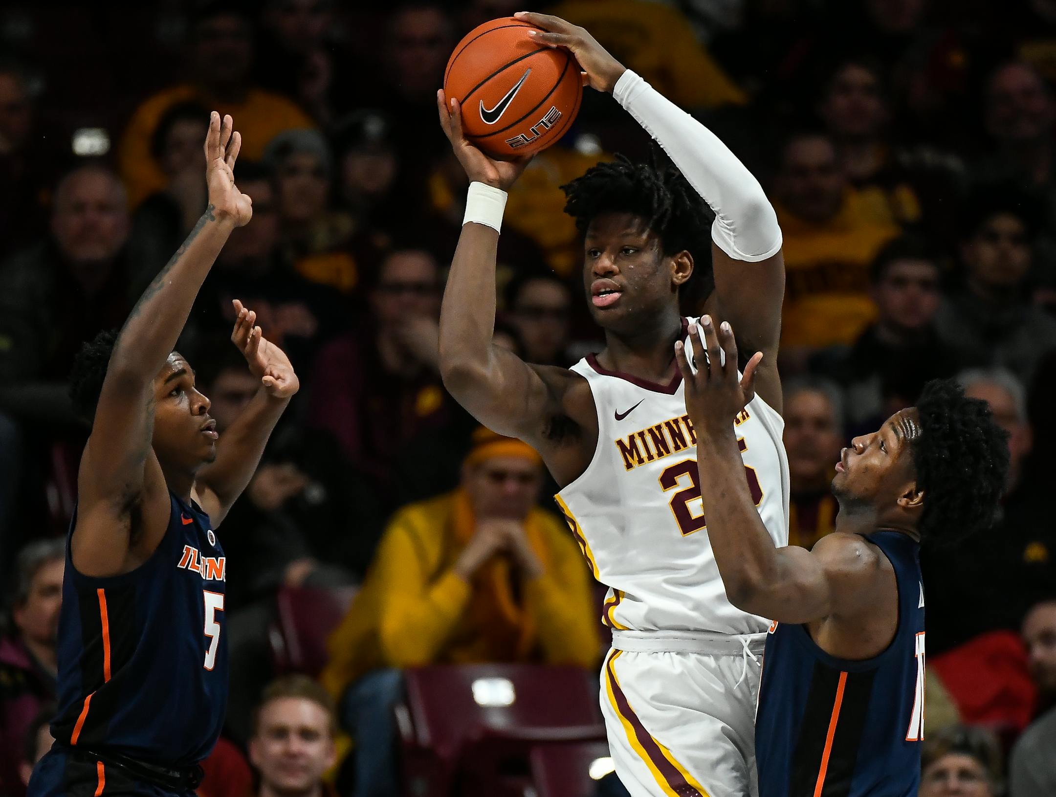 Minnesota Golden Gophers center Daniel Oturu (25) looked to pass the ball while being defended by Illinois Fighting Illini guard Tevian Jones (5) and guard Ayo Dosunmu (11). ] Aaron Lavinsky ¥ aaron.lavinsky@startribune.com The University of Minnesota Golden Gophers played the Illinois Fighting Illini on Wednesday, Jan. 30, 2019 at Williams Arena in Minneapolis, Minn.