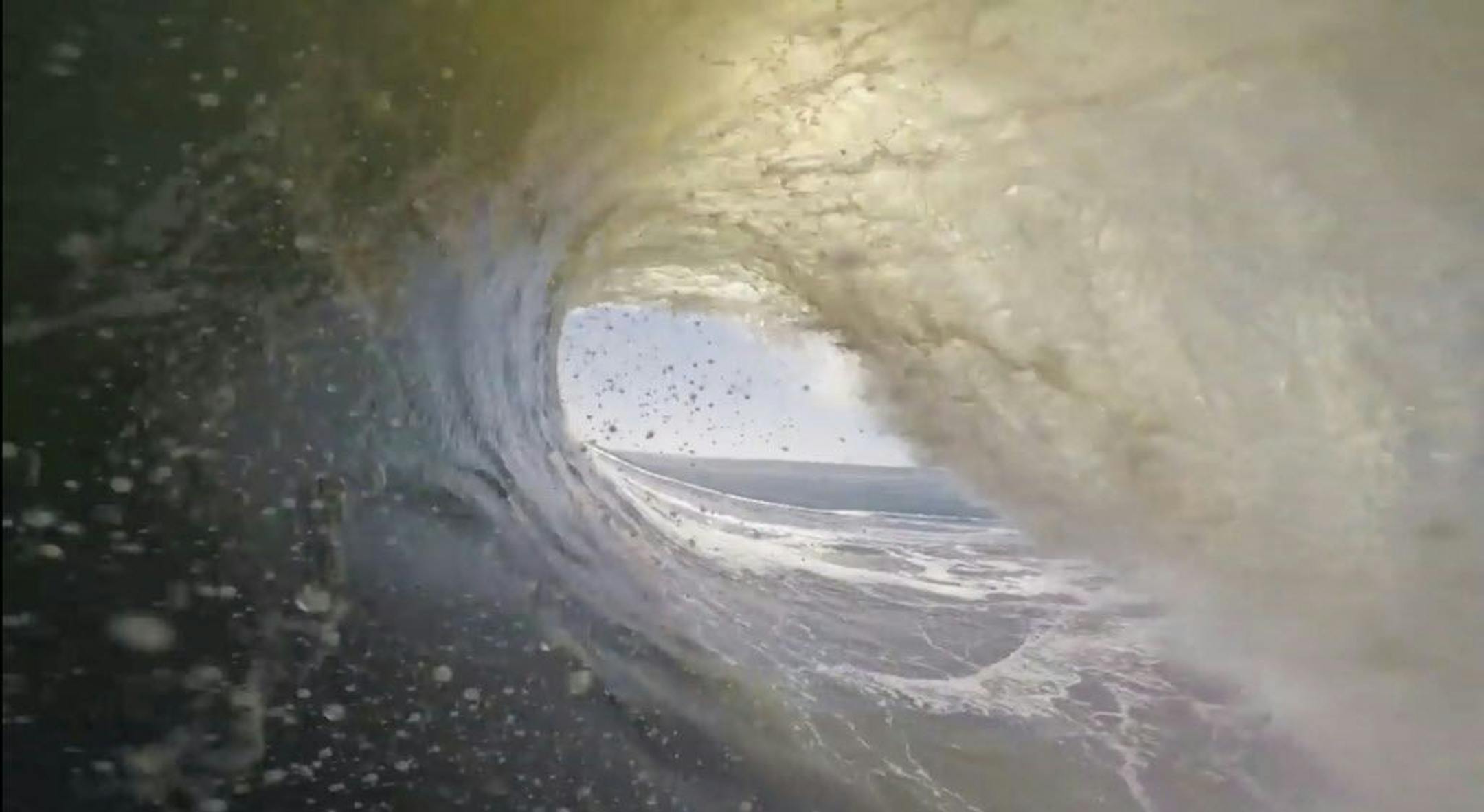 In this image made from video provided by Chris Rogers, surfer Koa Smith Smith rides through the barrel of a wave off the coast of Namibia, on the Western shore of Africa. Smith captured the action by wearing a small camera attached to a mouthpiece while he surfed. In what he called the ride of his life, Smith stayed upright, surfing through eight barrels on a nearly mile-long trip across a wave that lasted nearly two minutes.