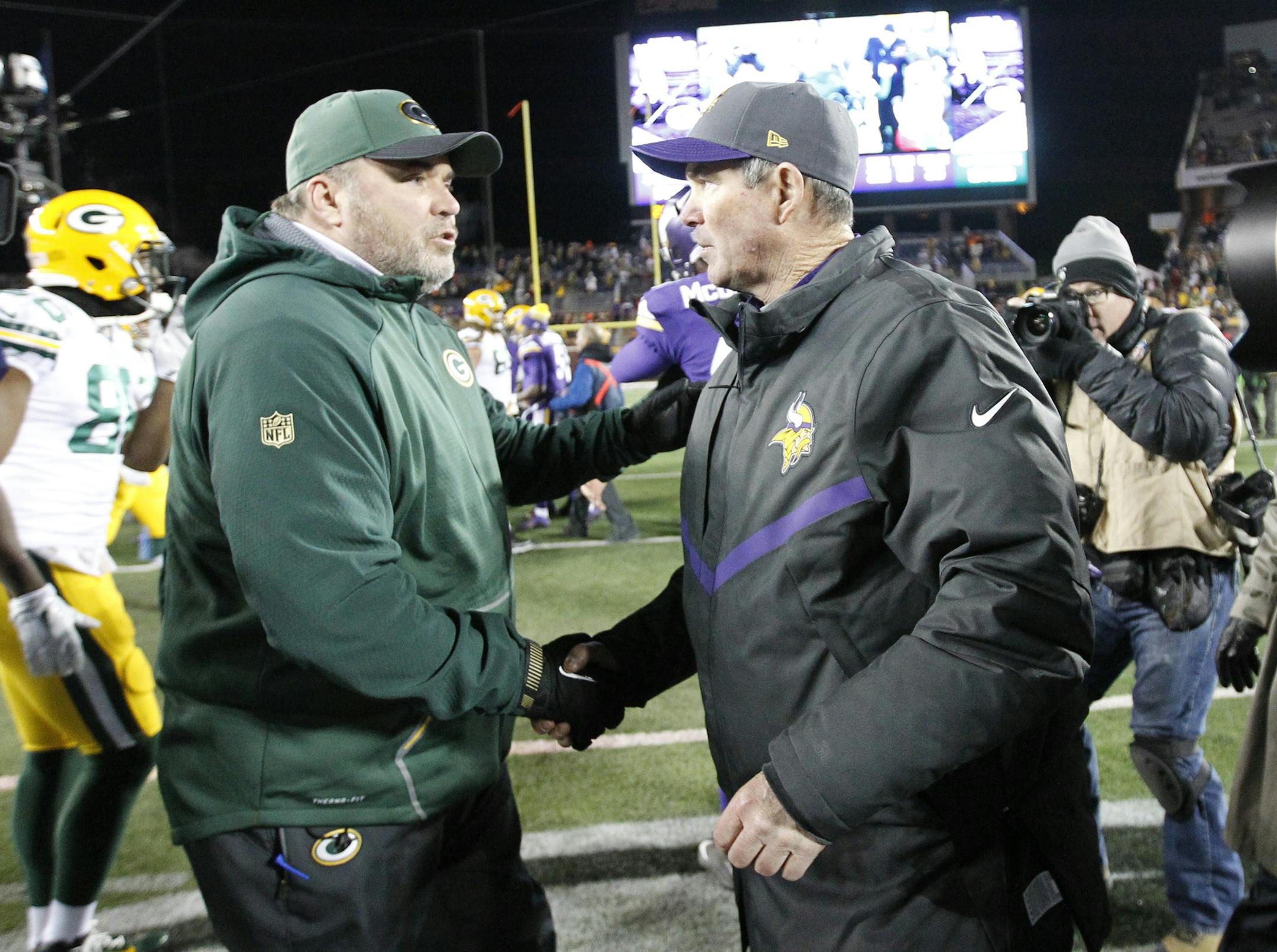 Green Bay Packers head coach Mike McCarthy meets with Minnesota Vikings head coach Mike Zimmer following an NFL football game in Minneapolis, Sunday, Nov. 22, 2015. The Packers defeated the Vikings 30-13. (AP Photo/Ann Heisenfelt)