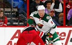 Minnesota Wild's Mikko Koivu (9) wins a face-off against the Carolina Hurricanes during the first period of an NHL hockey game, Saturday, Oct. 7, 2017