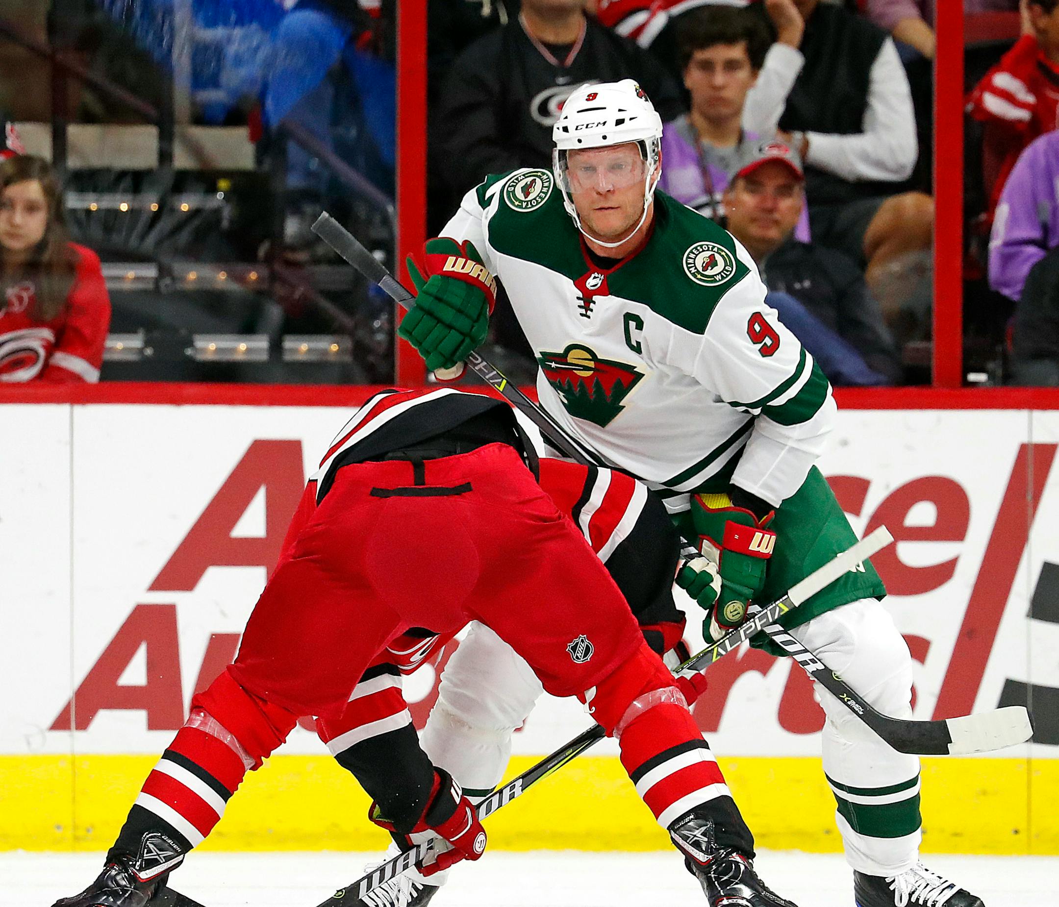 Minnesota Wild's Mikko Koivu (9) wins a face-off against the Carolina Hurricanes during the first period of an NHL hockey game, Saturday, Oct. 7, 2017, in Raleigh, N.C. (AP Photo/Karl B DeBlaker)