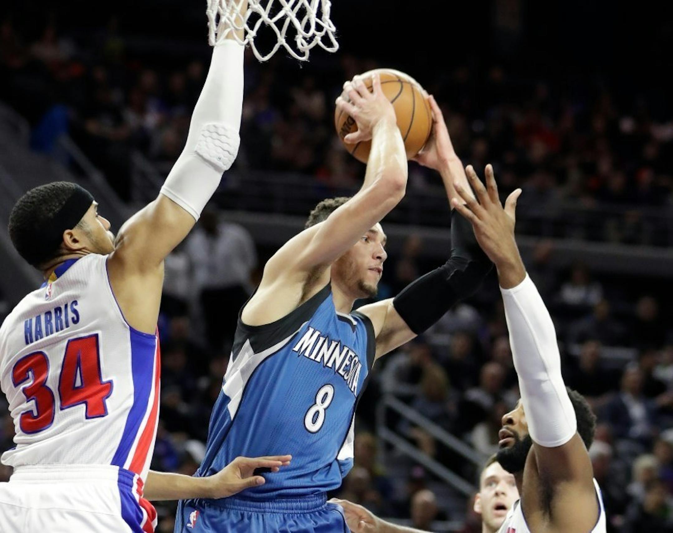 Zach LaVine (8) passes the ball as Detroit Pistons forward Tobias Harris (34) and center Andre Drummond, right, close in Friday night.