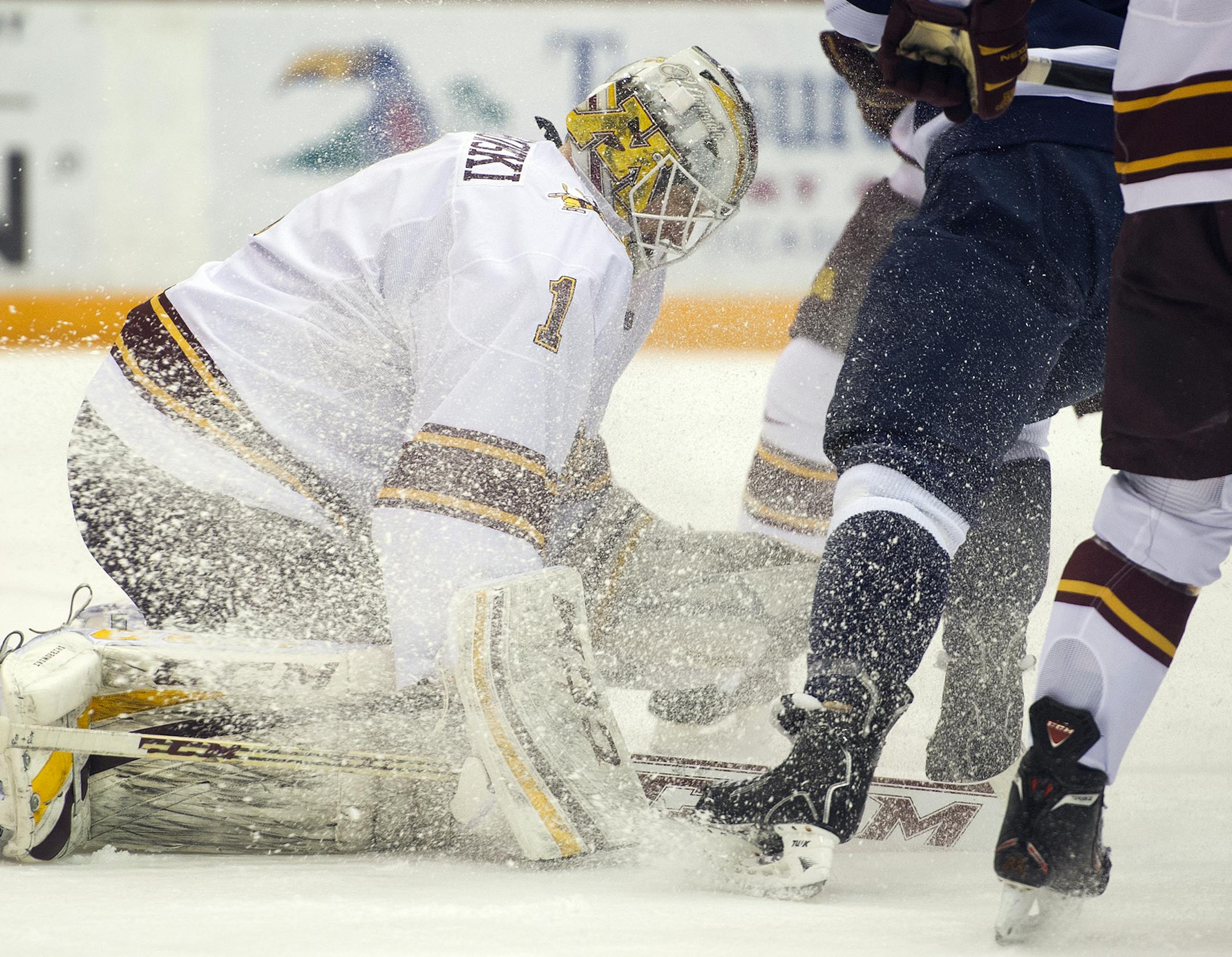 Minnesota goalie Michael Shibrowski is blasted with ice as he makes a save during the first period of Saturday night's game at Mariucci arena. ] (Matthew Hintz, 030114, Minneapolis)