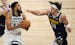 Denver Nuggets forward Aaron Gordon, right, applies to pressure to Minnesota Timberwolves center Karl-Anthony Towns during the first quarter of Game 4