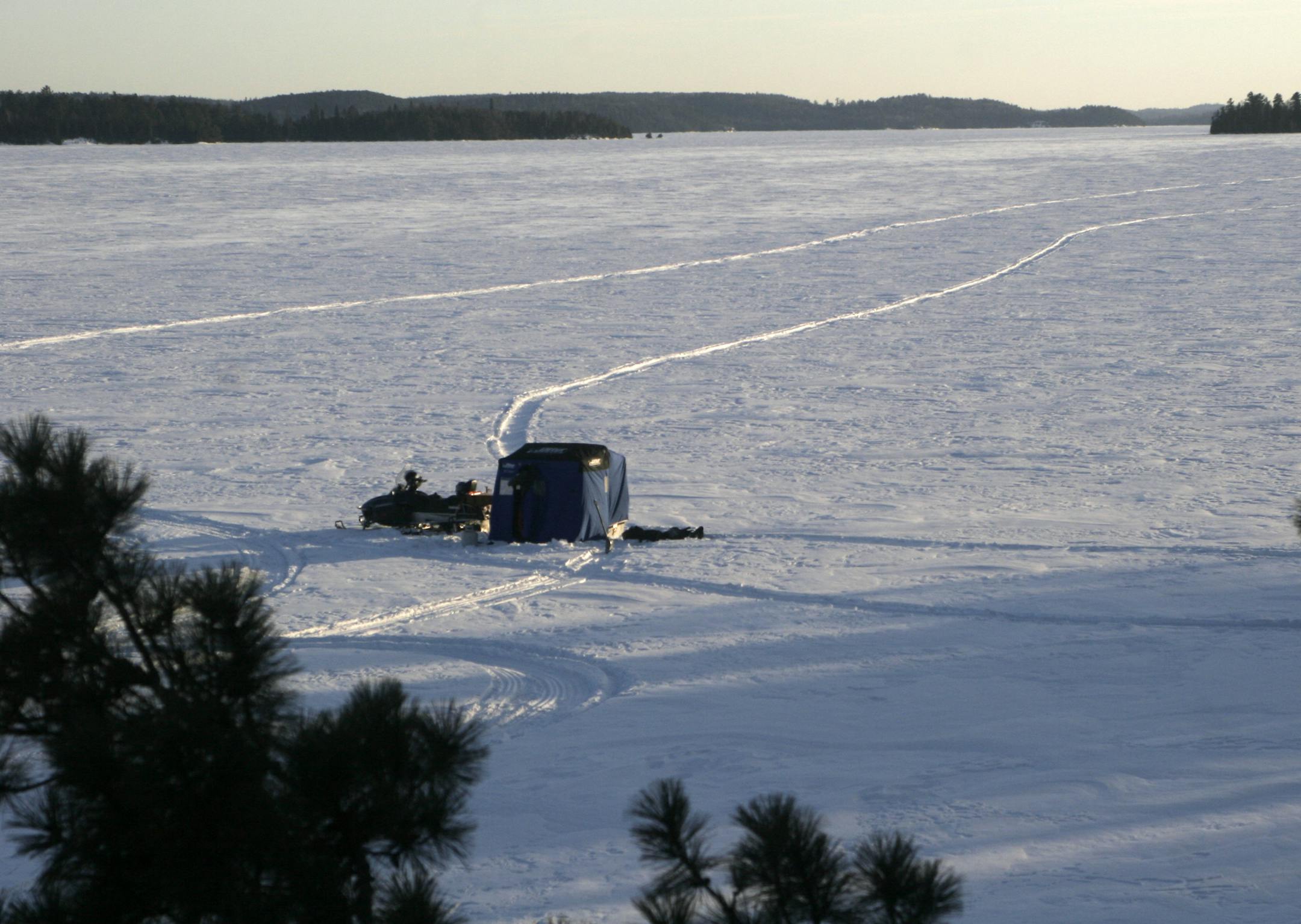 Minnesota anglers fished in their portable shelters for lake trout on an Ontario lake earlier in March. Wind and sub-zero temperatures foreced the anglers to fish inside their shelters most days. Star Tribune photo by Doug Smith