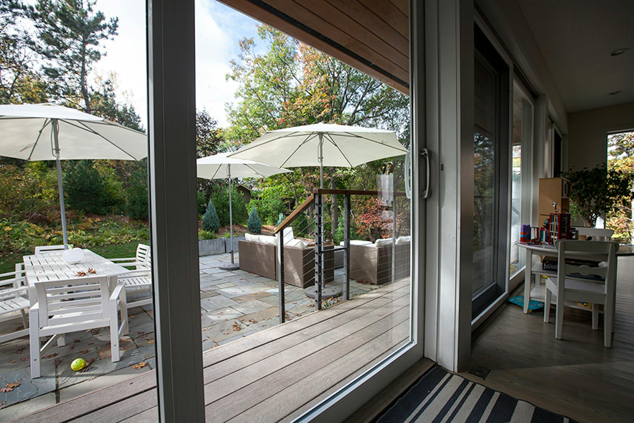 The kitchen's sliding door opens to a spacious outdoor room on the large wooded lot.