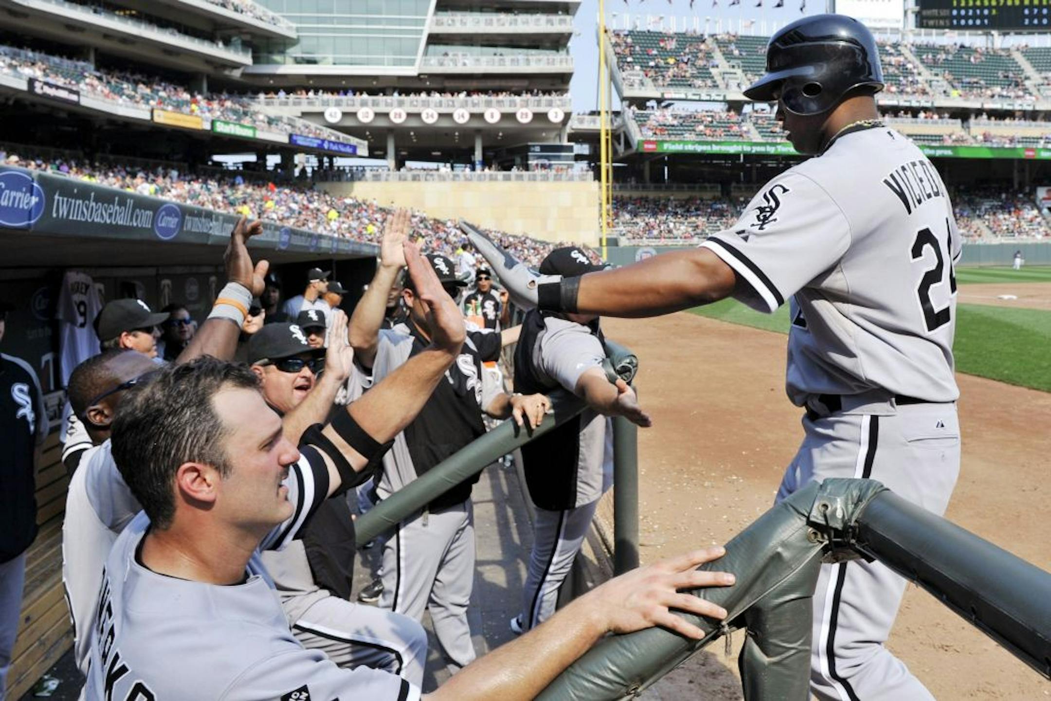 Chicago White Sox's Dayan Viciedo, right, is greeted in the dugout after his two-run home run off Minnesota Twins starting pitcher Scott Diamond in the sixth inning of a baseball game, Sunday, Sept. 16, 2012, in Minneapolis.