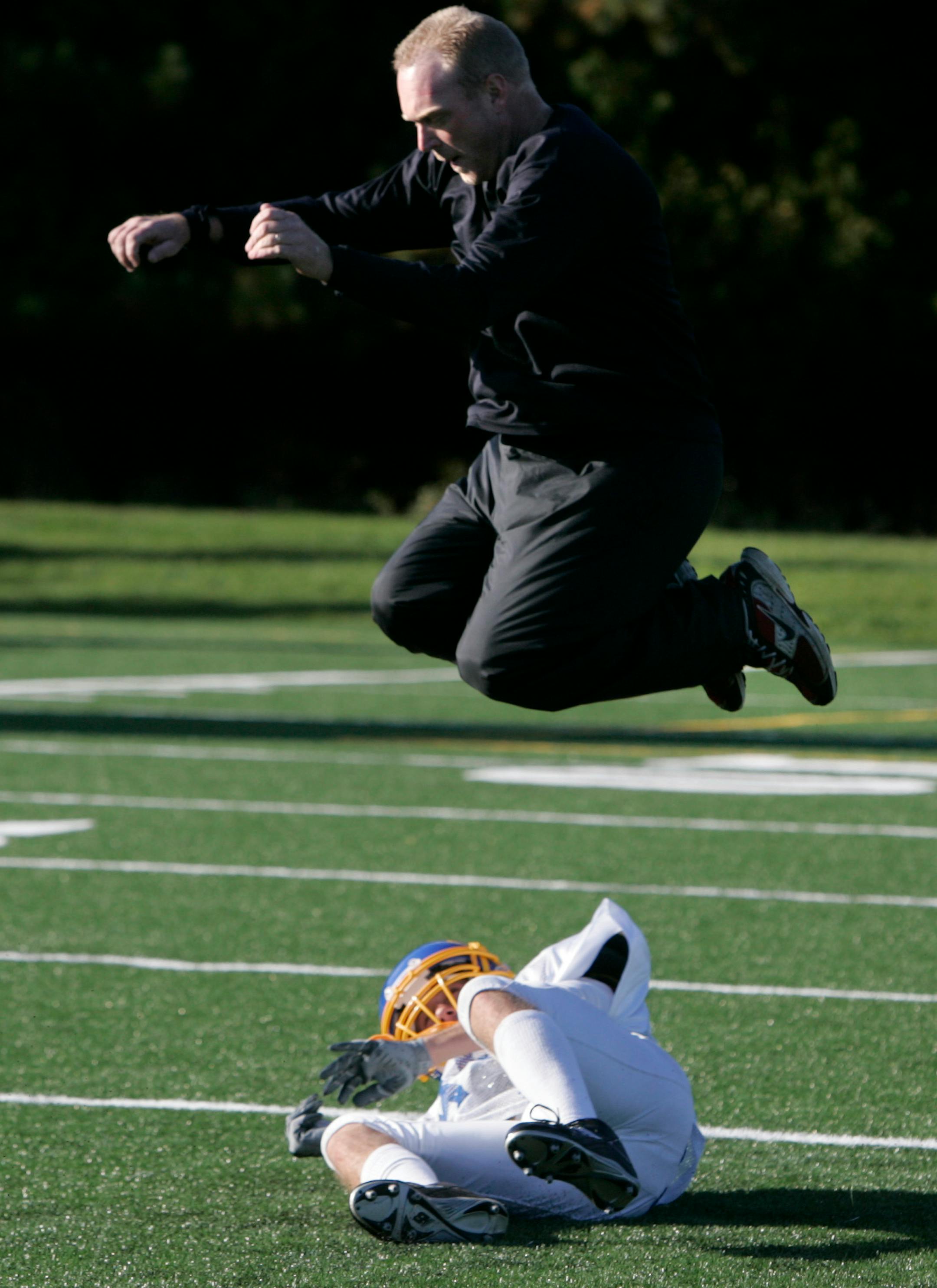 St. Scholastica assistant coach Scott Arntson wasn't in over his head when he joined players for a rolling drill.
