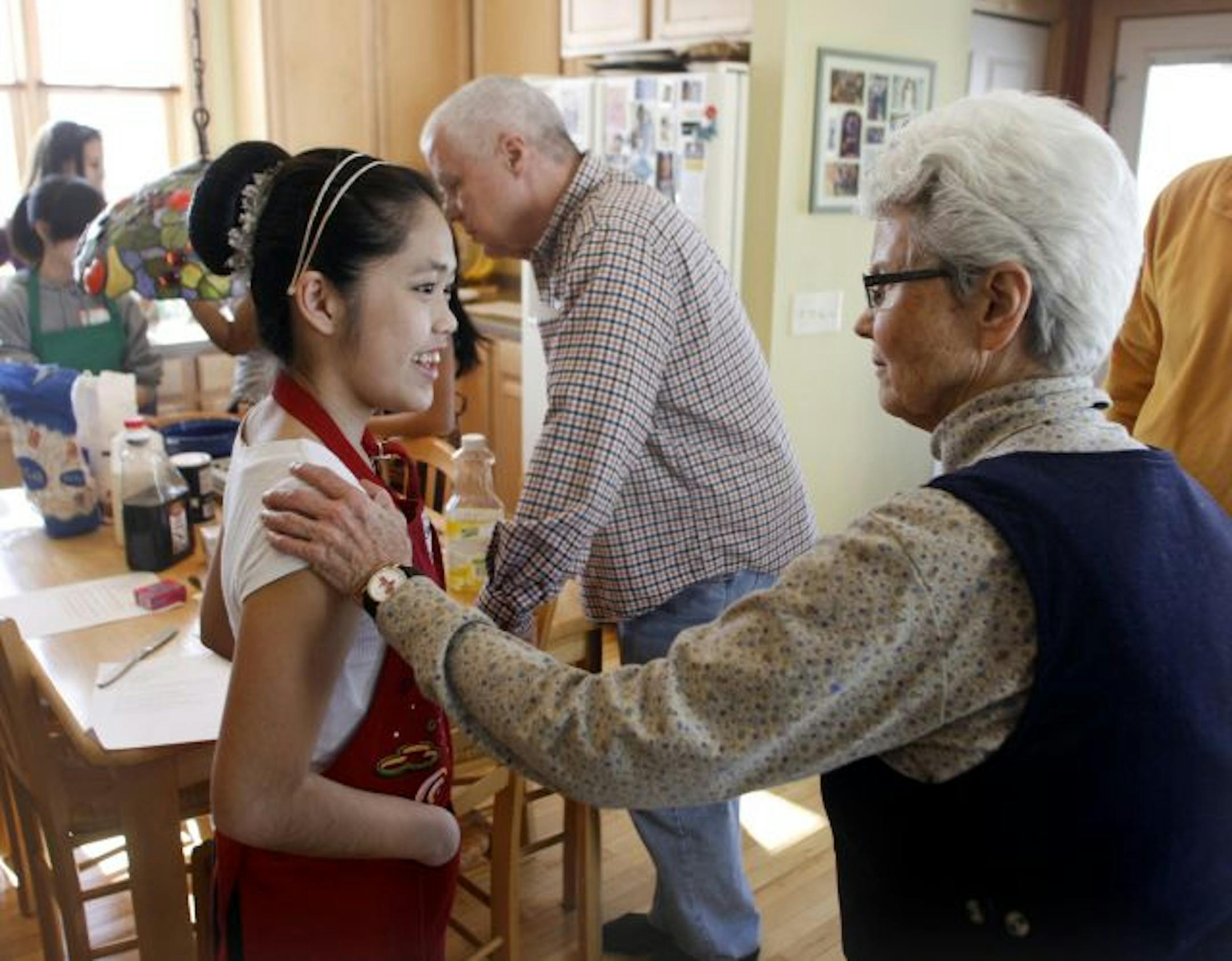 Pashoua Herr, left, talked with Sister Katherine Mullin about how school was going during a break at the teen baking event on Saturday.
