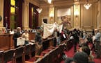 Opponents of the Upper Harbor Terminal redevelopment stood with their backs to the Minneapolis City Council following the unanimous approval of the pr