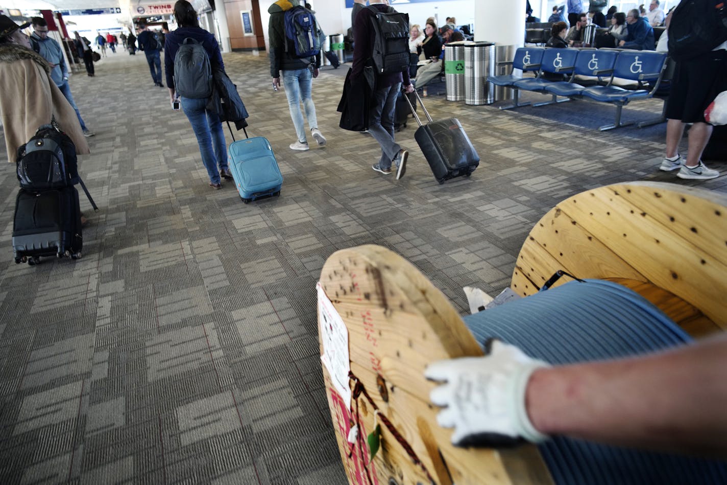 Worn areas of the gray carpet in both terminals at Minneapolis-St. Paul International Airport will be replaced in time for the Super Bowl. Richard Tsong-Taatarii/Richard.tsong-taatarii@startribune.com