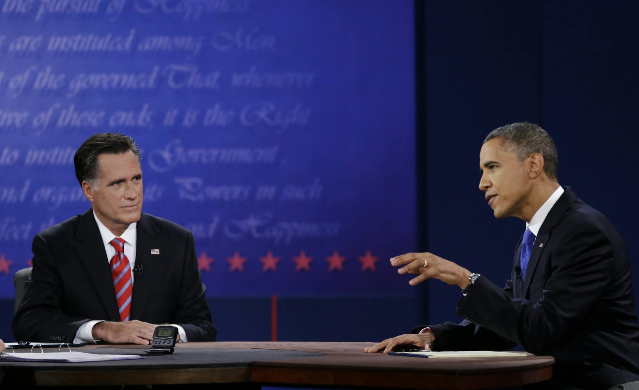Republican presidential nominee Mitt Romney, left, listens to President Barack Obama during the third presidential debate at Lynn University, Monday, Oct. 22, 2012, in Boca Raton, Fla.