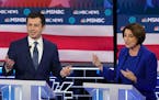 Pete Buttigieg and Sen. Amy Klobuchar (D-Minn.) look to the moderators during the Democratic presidential debate at the Paris Theater in Las Vegas, on