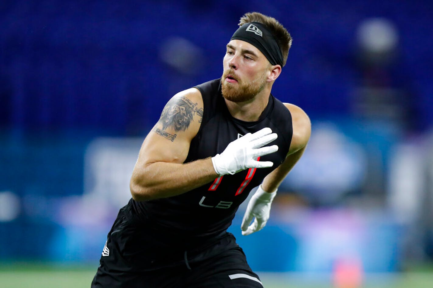 Minnesota linebacker Carter Coughlin runs a drill at the NFL football scouting combine in Indianapolis, Saturday, Feb. 29, 2020. (AP Photo/Michael Conroy)