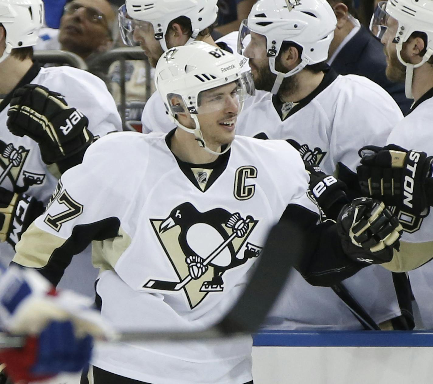 Teammates congratulate Pittsburgh Penguins center Sidney Crosby (87) who scored his first goal of the playoffs in the second period of a second-round NHL Stanley Cup hockey playoff game against the New York Rangers at Madison Square Garden in New York, Monday, May 5, 2014. (AP Photo/Kathy Willens)