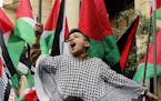 A child holds a Palestinian flag as he chants slogans during a sit-in in the Bourj al-Barajneh Palestinian refugee camp, in Beirut, Lebanon, Wednesday