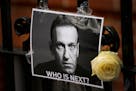 A flower and a picture are left as a tribute to Russian politician Alexi Navalny near the Russian embassy in London on Sunday.