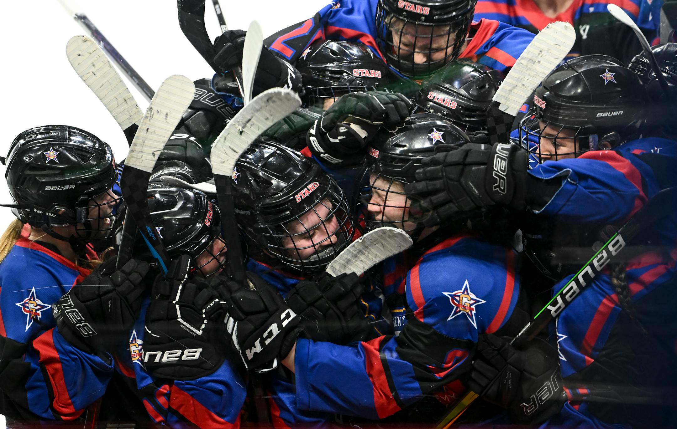 Teammates celebrate with Gentry forward Ellie Sarauer (18) after her game-winning goal in overtime against the Minnetonka Skippers.