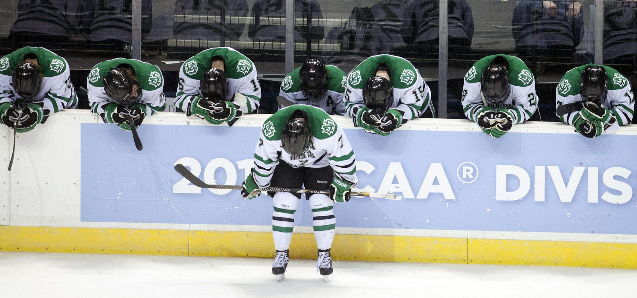 North Dakota teammates react after losing to Yale in their NCAA college hockey regional championship game, Saturday, March 30, 2013, in Grand Rapids, Mich. They lost 1-4. (AP Photo/The Grand Rapids Press, Latara Appleby) ALL LOCAL TV OUT; LOCAL TV INTERNET OUT.