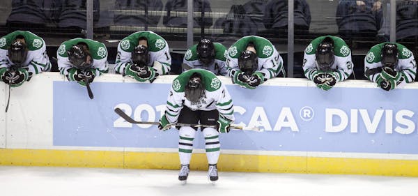 North Dakota teammates react after losing to Yale in their NCAA college hockey regional championship game, Saturday, March 30, 2013, in Grand Rapids, 