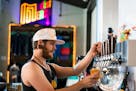 Bartender Cory Richter pours a beer at Modist Brewing in 2019.