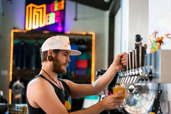 Bartender Cory Richter pours a beer at Modist Brewing in 2019.