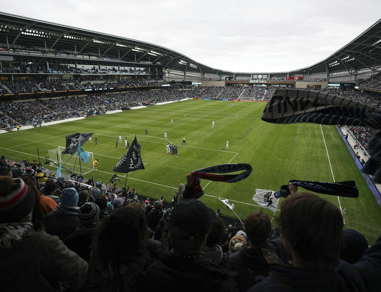 In this April 13, 2019, photo, Minnesota United wave their scarves as the team tried unsuccessfully for the game-winning goal in the second half against New York City FC in the home-opener for the MLS soccer match at Allianz Field in St. Paul, Minn. The first season for Minnesota United at Allianz Field has been a sold-out success. As the Loons prepare for their first MLS playoff game, they'll have their raucous supporters section behind them to help. (Anthony Souffle/Star Tribune via AP)