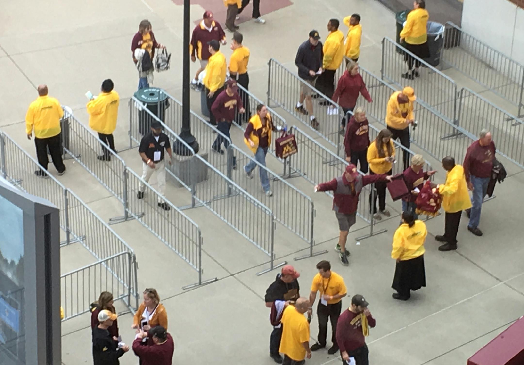 Fans go through security at TCF Bank Stadium this morning before today's game against Colorado State.